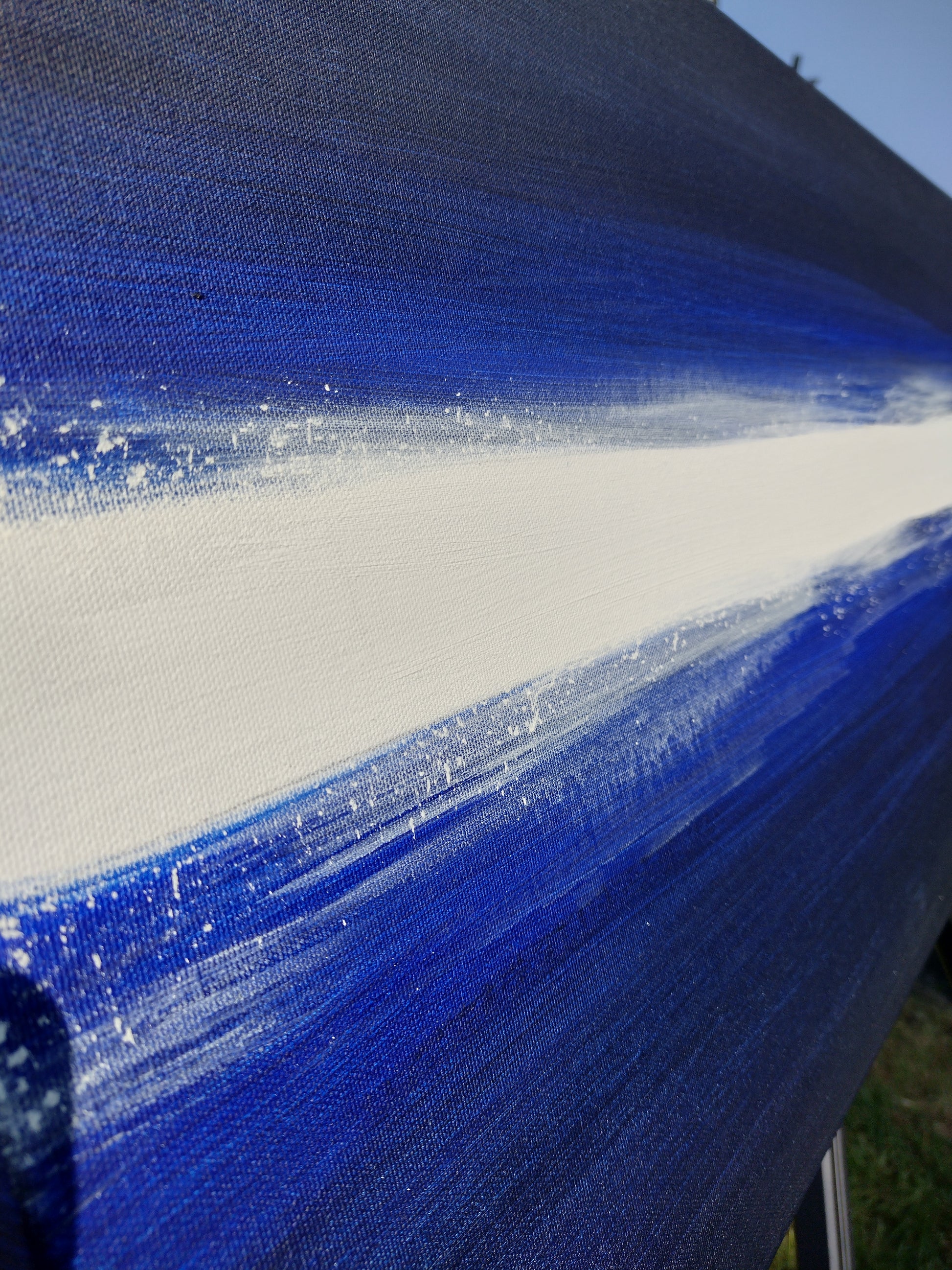 Image showing close-up of canvas painting 'Blues and Cocaine' Original art by Kathryn Mason, in deep blues and black with a splattered white stripe running horizontally through the centre