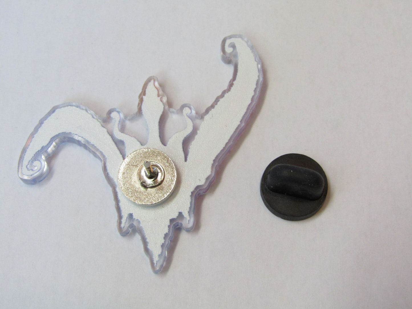 Photo showing back of pin badge