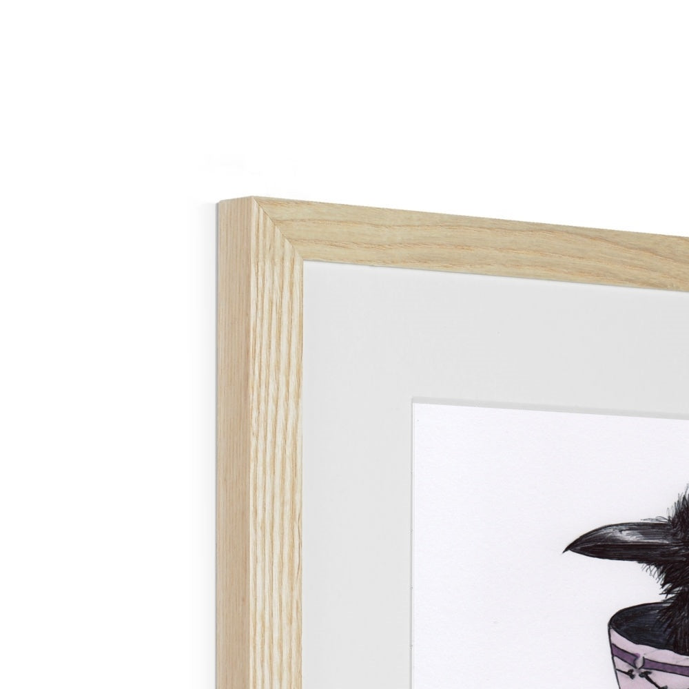 Photo showing corner edge view of 'Sheltering from a Storm in a Teacup' Cute Baby Crow Gothic Fine Art Print from artist Kathryn Mason's original drawing. Framed and Mounted. Shown here with wood frame.
