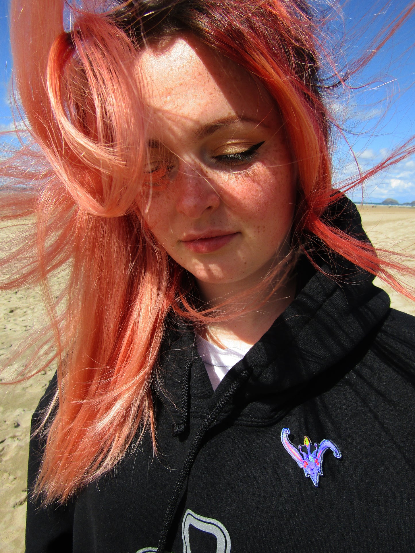 Photo of wind swept pretty girl wearing baph bun pin badge 